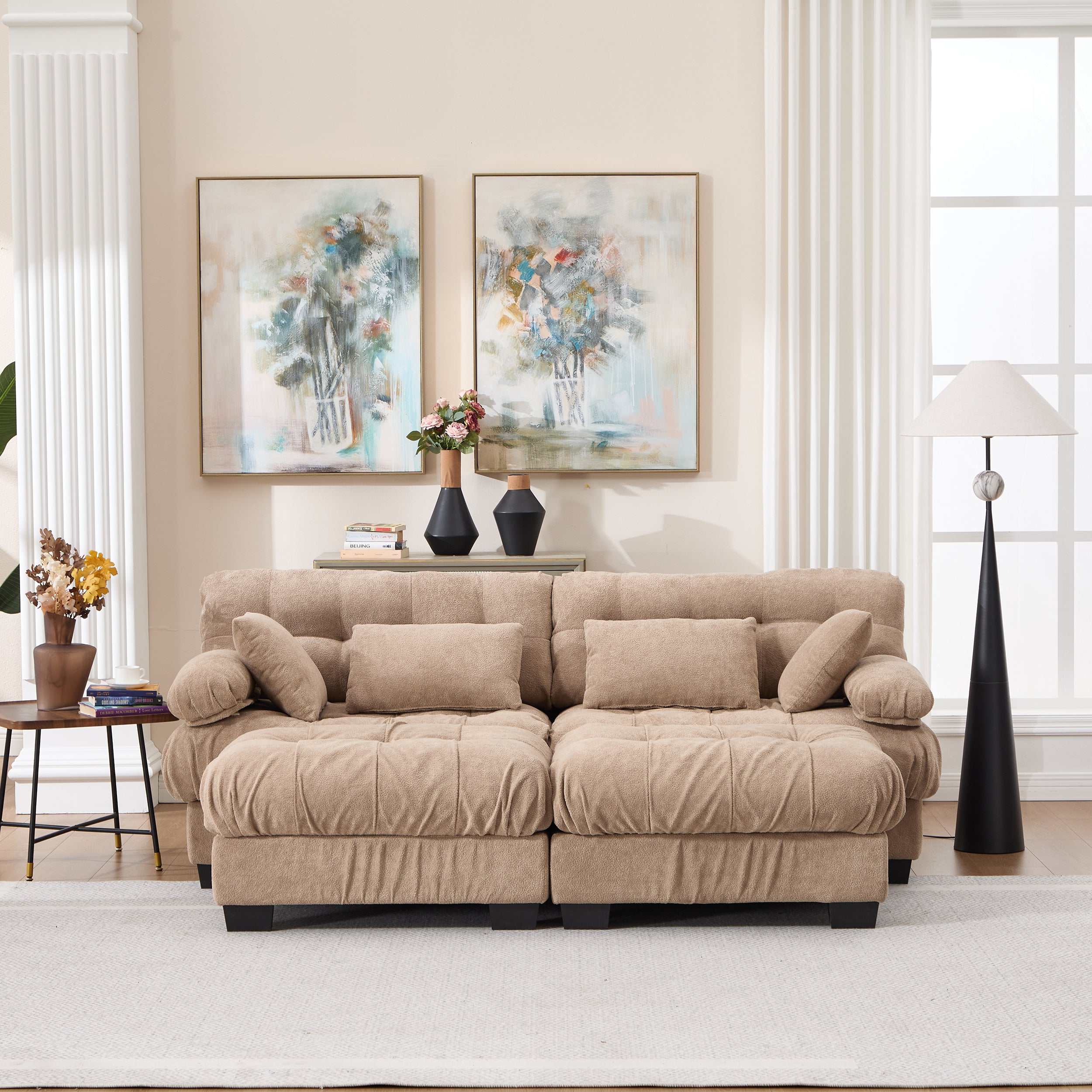 Modern light brown U shaped sectional couch with deep seats, round armrests, ottoman, and four pillows in living room setting