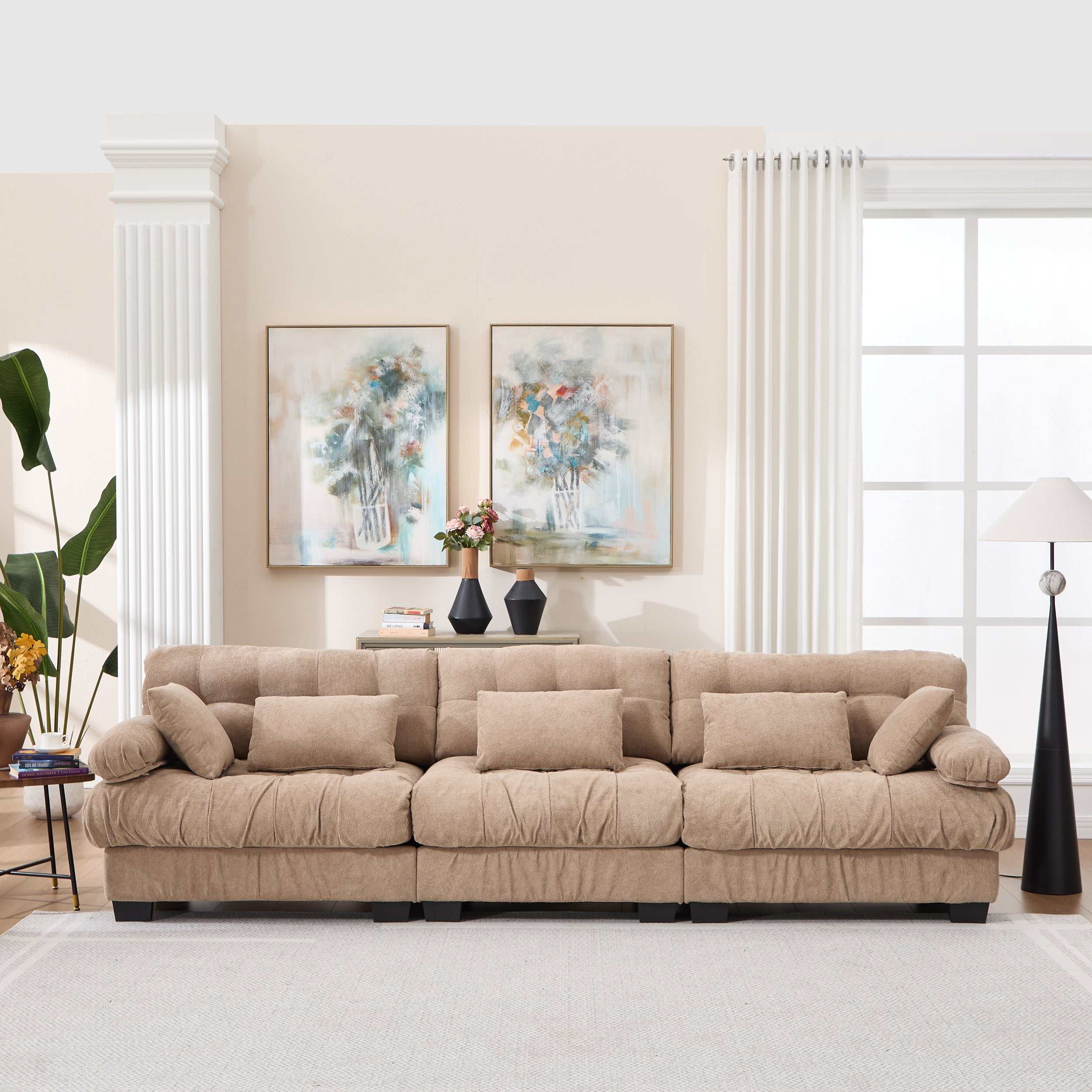 Modern light brown modular sectional sofa with deep seats and five throw pillows in living room setting