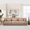 Modern light brown modular sectional sofa with deep seats and five throw pillows in living room setting