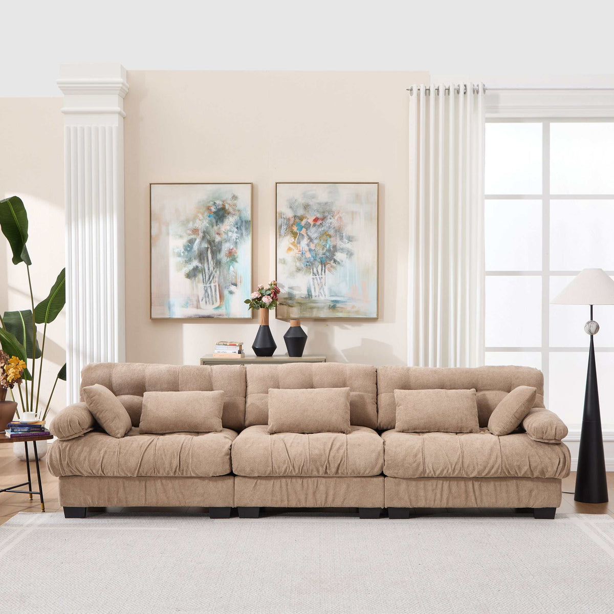 Modern light brown modular sectional sofa with deep seats and five throw pillows in living room setting