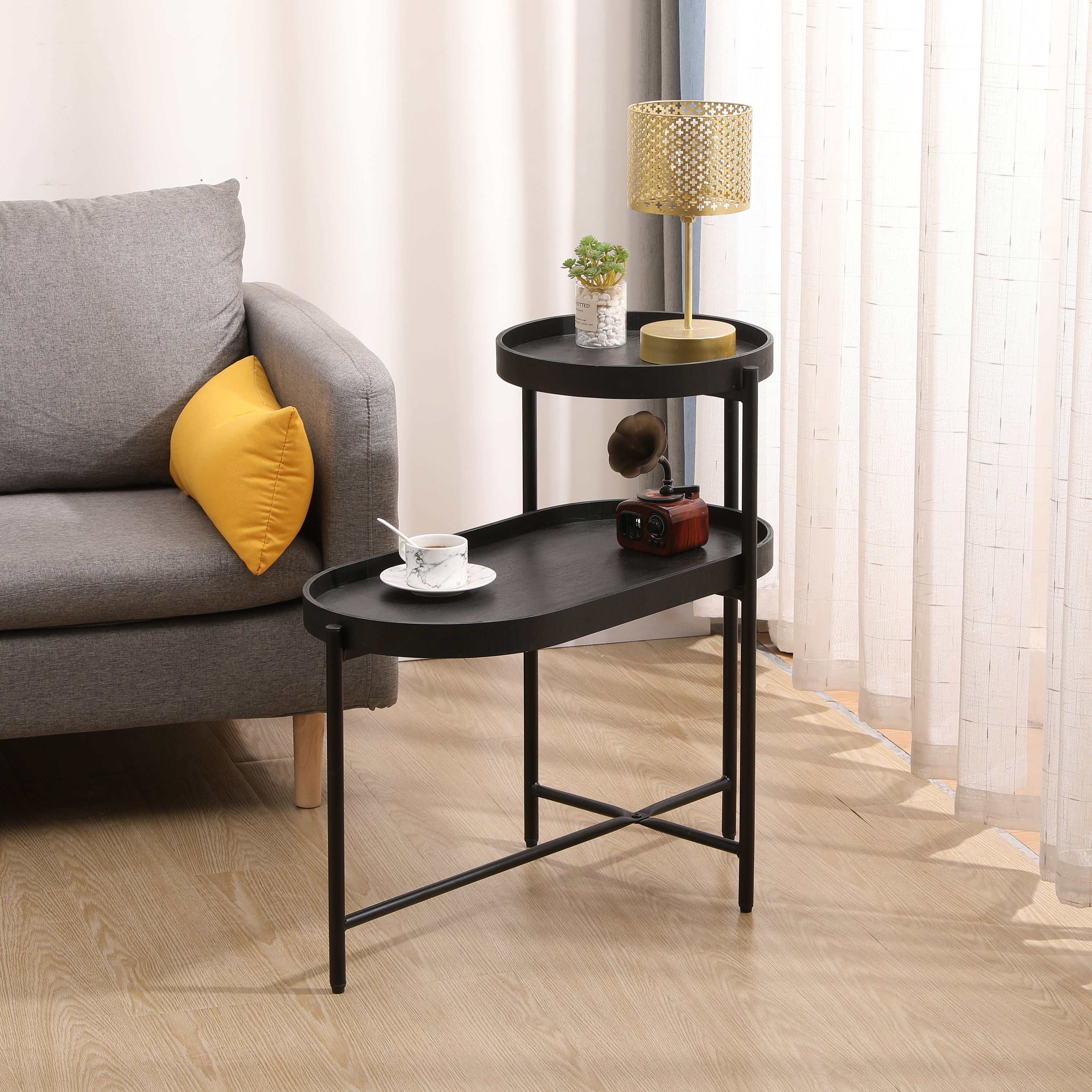 2-tier black side table with metal frame and wooden trays in modern living room setting